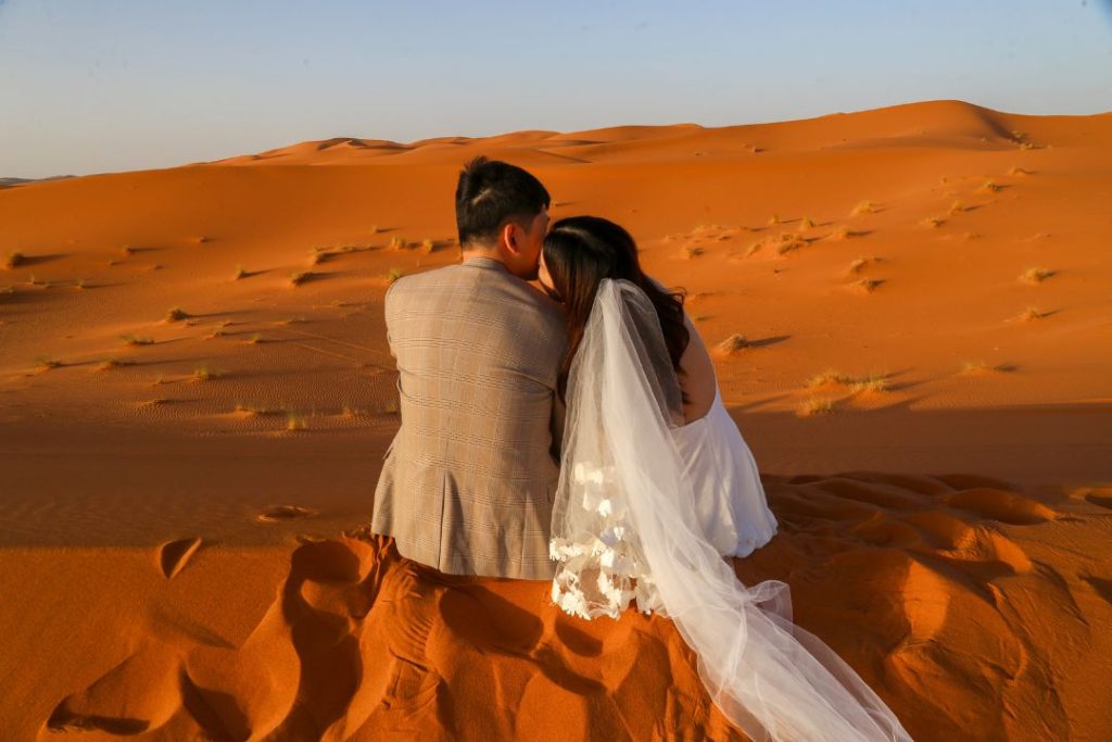 couple in desert of our Shared 3-day desert tour from Marrakech
